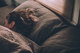 Woman sleeping with morning sunlight coming through the window.