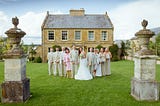 people posing outside wedding venue