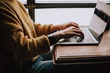 Women sitting at computer working remotely for design client.