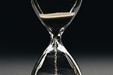 An hour-glass in motion for time management