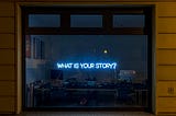 Neon Blue Sign that Reads What is Your Story