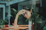 Disappointed girl sitting at a table.