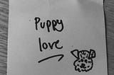 Black and white photo with ‘Puppy love’ and a cartoon dog written in black marker on a Post-It note