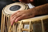 close up color photograph of person playing the djeme drums