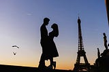 Silhouette of a couple embracing in front of the Eiffel Tower at sunset, symbolizing the allure and romanticized facade of relationships, contrasted with the underlying complexities and darker aspects of swinging and marital exploitation.