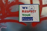 We respect your privacy sign over red graffiti.