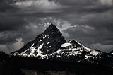 black and white picture of a huge mountain with snow fields