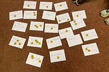A selection of principles written on white paper with voting tokens on top