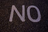 the word NO written on the street.