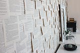 Image of a wall covered with printed pages.