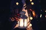 Person holding a lantern