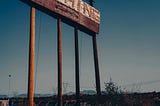 An old faded billboard that reads, “NOTHING”.