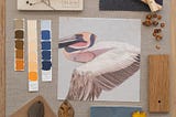 Mood board featuring a Tale Tree fabric swatch with a pelican design surrounded by color swatches and natural materials.