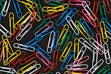 Colored paper clips spread out on a table
