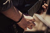 A photo of a guitarist playing a guitar.