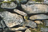 Pile of heavy uneven stones with moss between