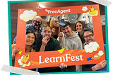 Seven members of the FreeAgent Design team, including Finn McEwan, the author of this piece, pose within a large illustrated picture frame created for FreeAgent’s LearnFest.