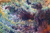 
This scar on an arid landscape is the dry riverbed of the Ghadamis River in the Tinrhert Hamada Mountains near Ghadamis, Libya.