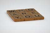 Scrabble pieces that says WHO ARE YOU?