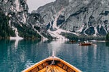 boat in the water pointing toward mountains