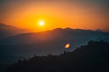 Sunlight from behind mountains