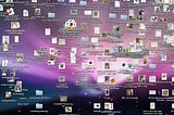 A Macook desktop screen filled with a chaotic spread of files and folders