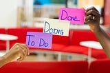 A picture with 3 sticky notes held up “To Do” “Doing” “Done”