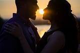 Silhouette of a man and women staring loving at each other