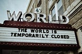 A sign with the words the world is temporarily closed on it.