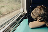 woman sleeping on a train