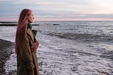 Young woman at the beach during sunset