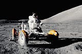 Astronaut driving a moon-buggy on the moon’s surface