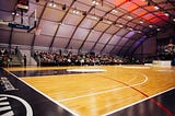 Basketball court with fans seated in the bleachers