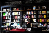 Woman in a bookshop holding a book