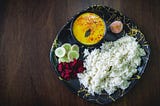 Kadhi chawal (Kadhi Rice) traditional north indian food, with some salad and sweet.