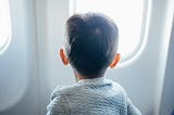 Photo shows a small boy looking out the world.