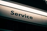 Street sign with the word “Service” lit up from above
