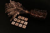 Image of dry bouquet on its side with the words ‘get well soon’ in scrabble letters in the foreground.