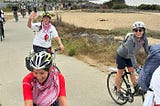 Bicyclists along the Bay Trail wearing helmets and keffiyehs smile and wave as they complete the Ride for Palestine.