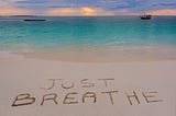 Breathwork headline image: “just breathe” on beach