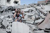 A girl sitting in the ruins of a bombed out building