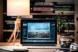 Open laptop on a desk with software loaded.