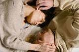A man and a woman caressing each other’s heads