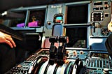 Flight deck of a passenger aircraft displaying complex set of controls.