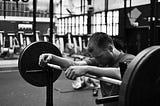 Man stands tired at a barbell