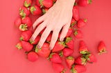 In the background is depicted strawberries.