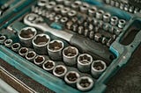 Production features vs fixing nuts, bolts and tools