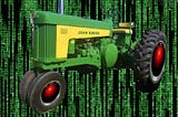 A vintage John Deere tractor whose wheel hubs have been replaced with HAL 9000 eyes, matted over a background of the cyber-waterfall image from The Matrix.