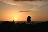 silhouettes of two girls at sunset.