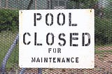 Sign: “Pool Closed for Maintenance”